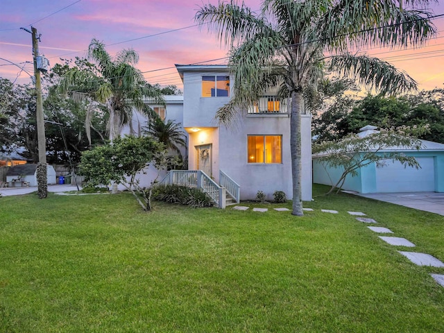 10 Seminole Dr, Saint Augustine, FL 32084 - view of front of house with stucco siding, concrete driveway, a front yard, and a balcony