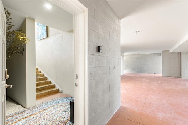 136 Lawn Ave, Saint Augustine, FL 32084 - stairs with tile patterned floors and concrete block wall