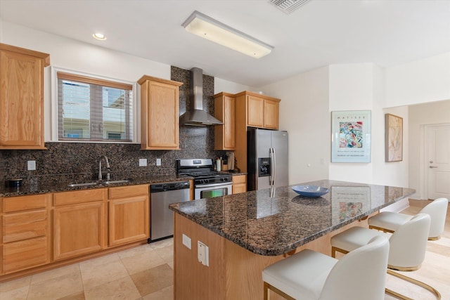 136 Lawn Ave, Saint Augustine, FL 32084 - kitchen with wall chimney exhaust hood, appliances with stainless steel finishes, decorative backsplash, a breakfast bar area, and a kitchen island