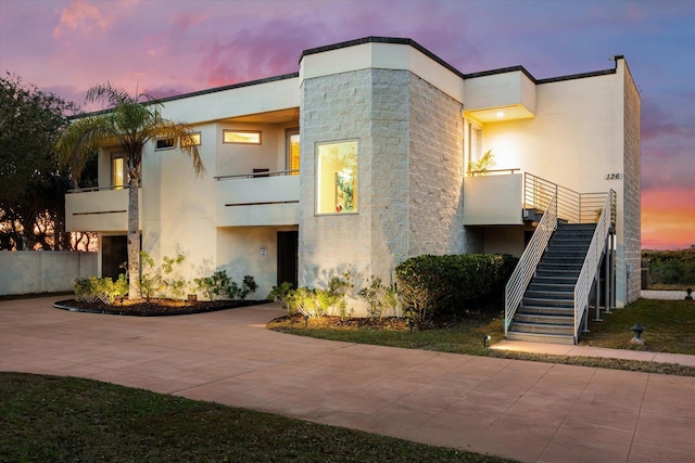 136 Lawn Ave, Saint Augustine, FL 32084 - contemporary house with stairway, stucco siding, and a balcony