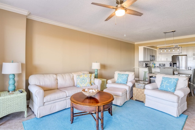 tiled living room with a textured ceiling, ceiling fan, and crown molding