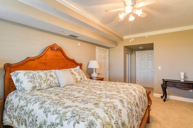 bedroom featuring ornamental molding, light colored carpet, ceiling fan, and a textured ceiling