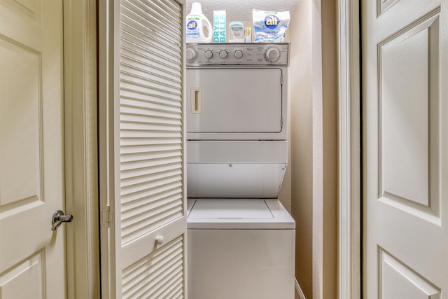 laundry room with stacked washing maching and dryer