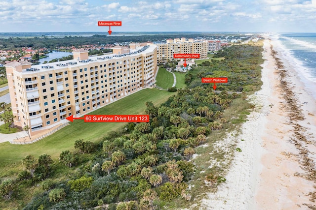 drone / aerial view featuring a beach view and a water view