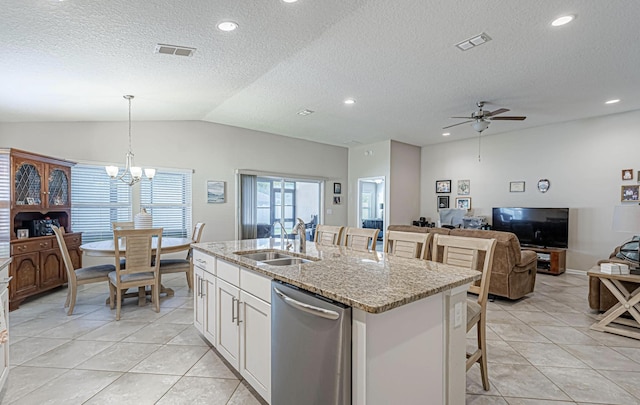 kitchen with stainless steel dishwasher, sink, pendant lighting, white cabinets, and an island with sink