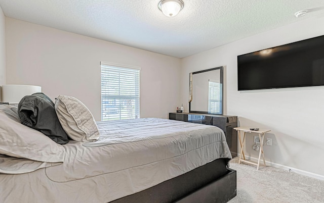 carpeted bedroom with a textured ceiling