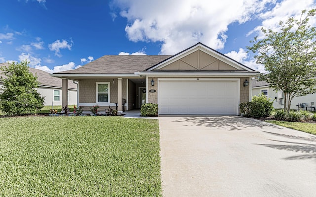 view of front of home with a front yard and a garage