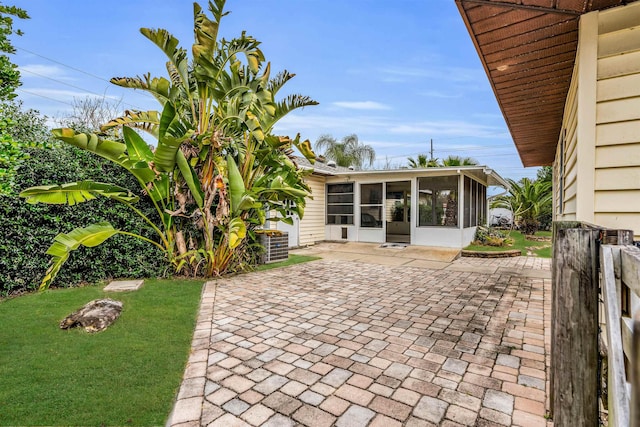 view of patio featuring a sunroom