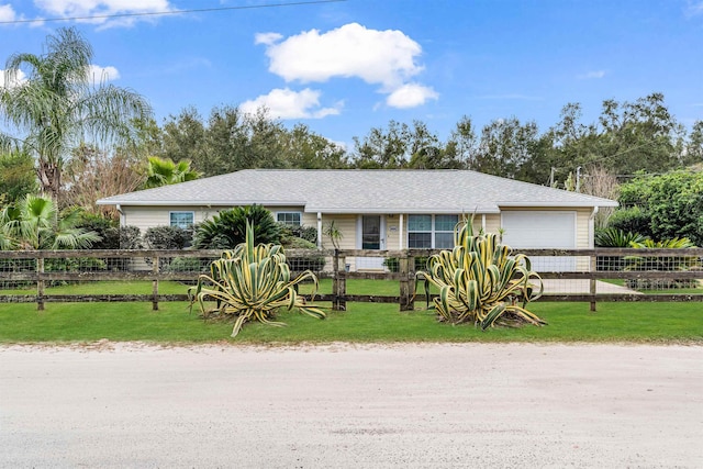 ranch-style house featuring a garage and a front yard