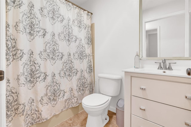 bathroom featuring tile patterned flooring, vanity, and toilet