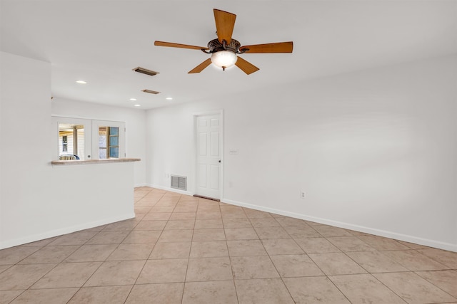 empty room with light tile patterned flooring and ceiling fan