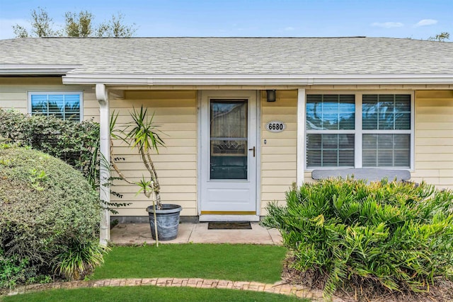 doorway to property with a lawn