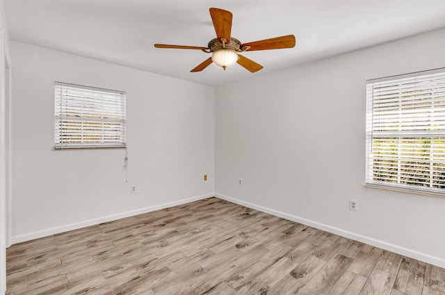 spare room featuring ceiling fan and light hardwood / wood-style flooring