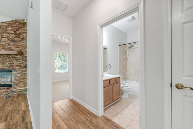5827 Green Rd, Middleburg, FL 32068 - full bathroom featuring vanity, shower / bath combination, wood finished floors, toilet, and a fireplace