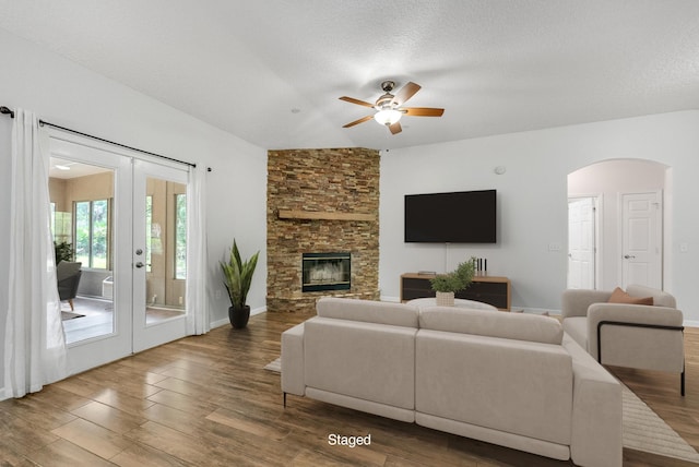 5827 Green Rd, Middleburg, FL 32068 - living room with a ceiling fan, french doors, wood finished floors, arched walkways, and a fireplace