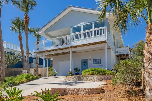 view of front of property featuring concrete driveway and an attached garage