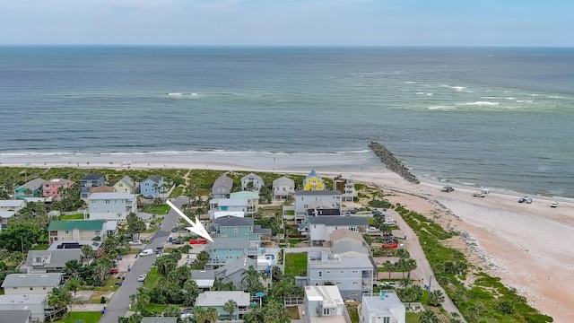 drone / aerial view featuring a water view and a beach view