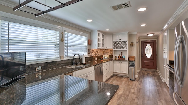 kitchen with white cabinetry, sink, crown molding, and appliances with stainless steel finishes