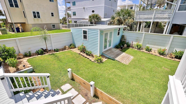 view of yard with french doors and an outdoor structure