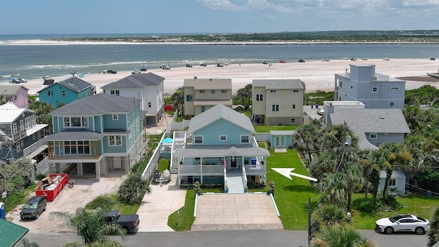 aerial view with a water view and a beach view