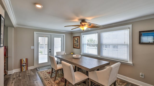 dining space with dark hardwood / wood-style flooring, crown molding, plenty of natural light, and ceiling fan