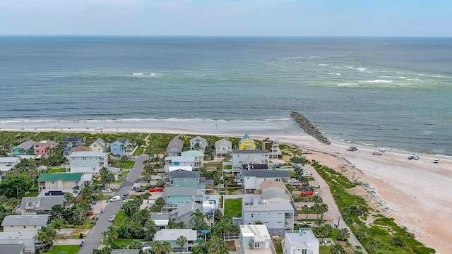 drone / aerial view featuring a water view and a beach view