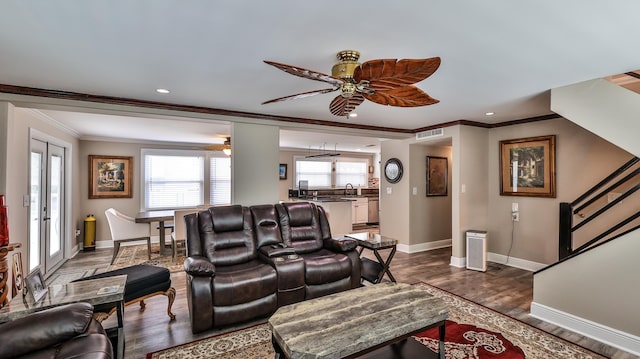 living room featuring french doors, crown molding, ceiling fan, and dark wood-type flooring