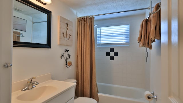 full bathroom featuring vanity, shower / tub combo, a textured ceiling, and toilet