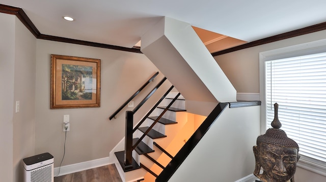 stairs featuring hardwood / wood-style flooring and ornamental molding