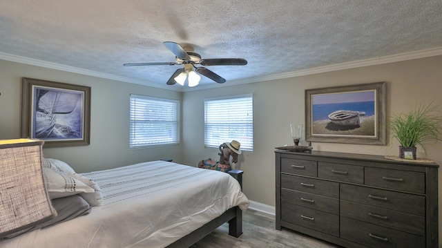 bedroom featuring a textured ceiling, ceiling fan, light wood-type flooring, and crown molding