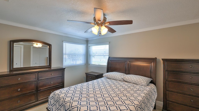 carpeted bedroom featuring a textured ceiling, ceiling fan, and ornamental molding