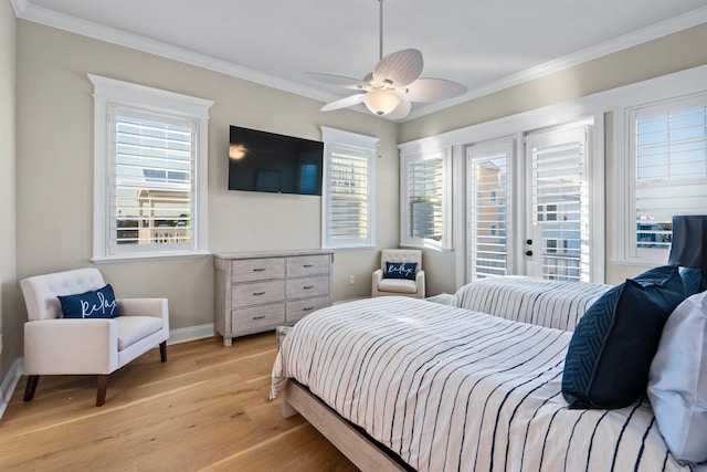 bedroom featuring ornamental molding, access to exterior, light hardwood / wood-style floors, and multiple windows