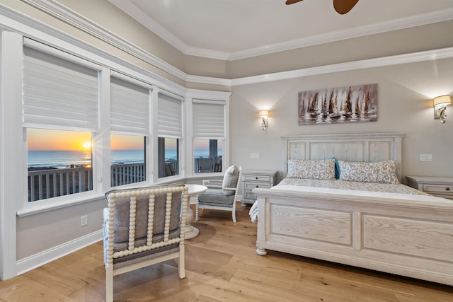 bedroom featuring ornamental molding and light hardwood / wood-style flooring