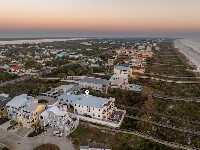 aerial view at dusk with a water view