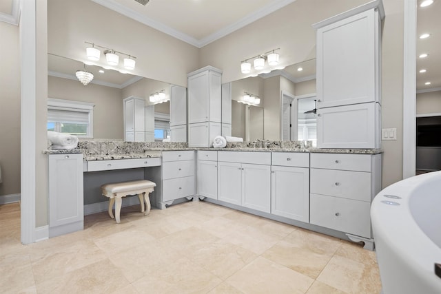 bathroom with vanity, crown molding, and a tub to relax in