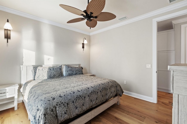 bedroom with crown molding, ceiling fan, and light hardwood / wood-style flooring