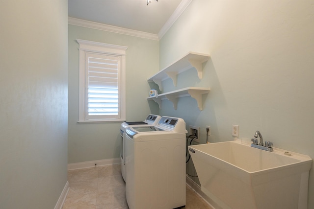 laundry room with ornamental molding, separate washer and dryer, sink, and light tile patterned floors