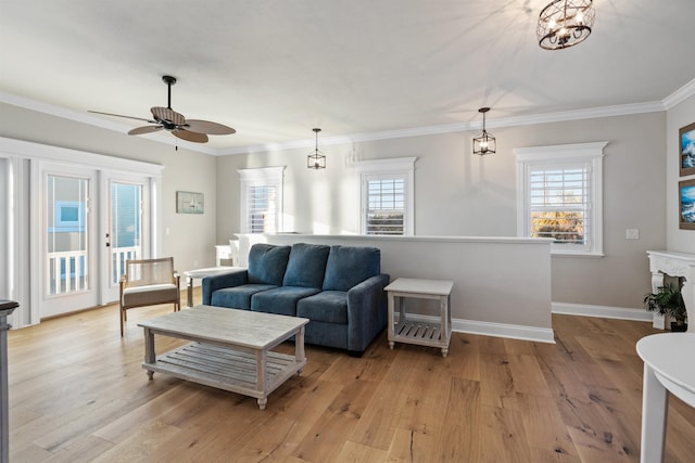 living room with crown molding, a healthy amount of sunlight, and light wood-type flooring