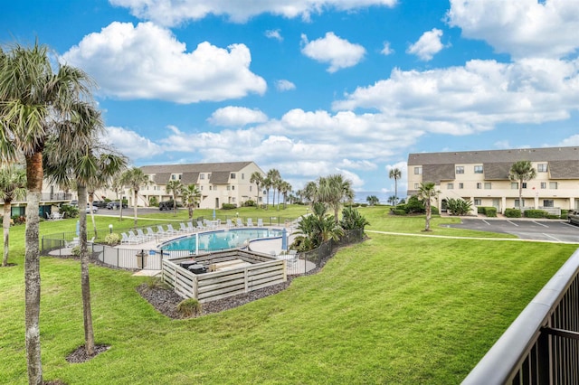 view of swimming pool with a yard