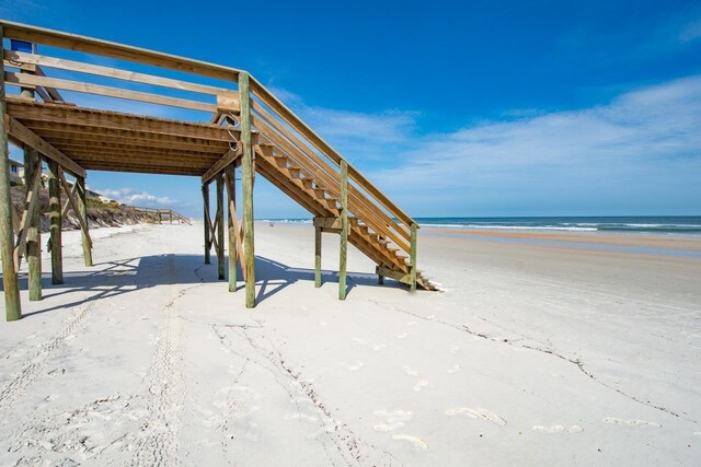 exterior space with a water view and a beach view