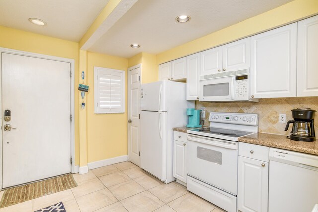 kitchen featuring white cabinets, white appliances, light tile patterned floors, and tasteful backsplash