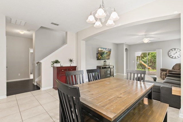117 Mission Cove Cir, Saint Augustine, FL 32084 - dining area with arched walkways, light tile patterned floors, a chandelier, and baseboards