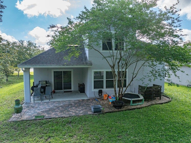 117 Mission Cove Cir, Saint Augustine, FL 32084 - rear view of house featuring stucco siding, a lawn, a patio area, and roof with shingles