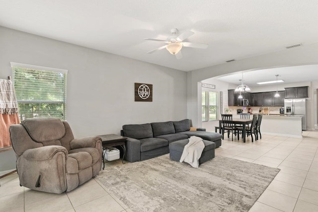 117 Mission Cove Cir, Saint Augustine, FL 32084 - living area featuring light tile patterned flooring, a chandelier, a ceiling fan, and arched walkways