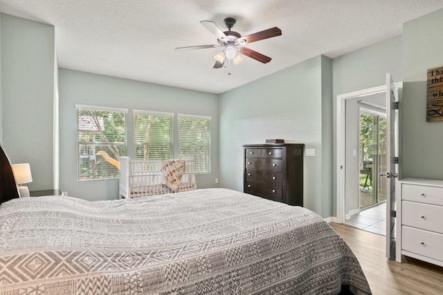 117 Mission Cove Cir, Saint Augustine, FL 32084 - bedroom featuring light wood finished floors, a ceiling fan, and a textured ceiling