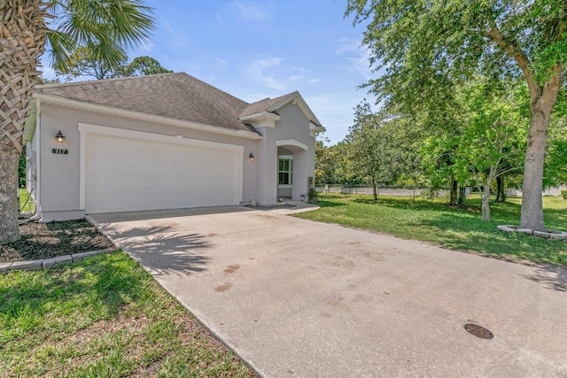 117 Mission Cove Cir, Saint Augustine, FL 32084 - view of front facade with concrete driveway, a garage, stucco siding, and roof with shingles