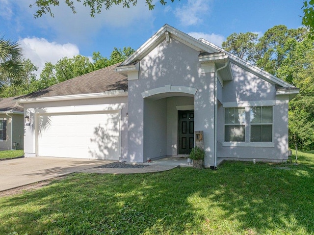 117 Mission Cove Cir, Saint Augustine, FL 32084 - view of front of house featuring a garage, a front yard, driveway, and stucco siding