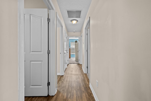 461 S Nassau St, Saint Augustine, FL 32084 - hall featuring dark wood-type flooring, a textured ceiling, and baseboards