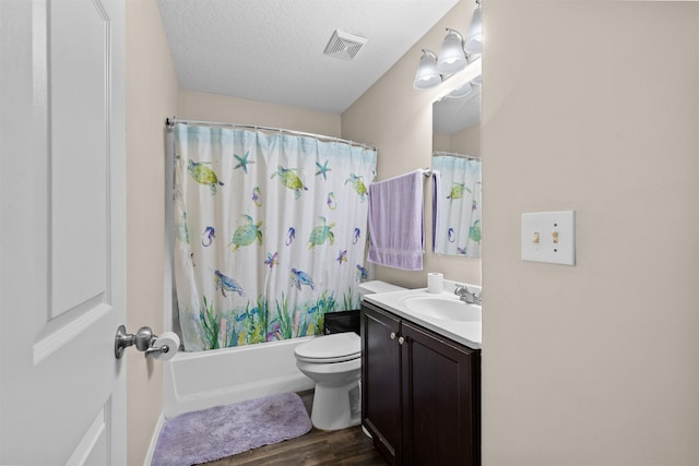 461 S Nassau St, Saint Augustine, FL 32084 - full bath featuring wood finished floors, vanity, toilet, shower / bathtub combination with curtain, and a textured ceiling