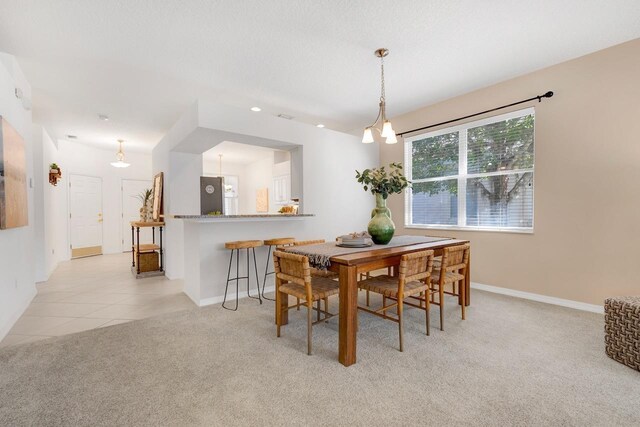 dining room with light carpet